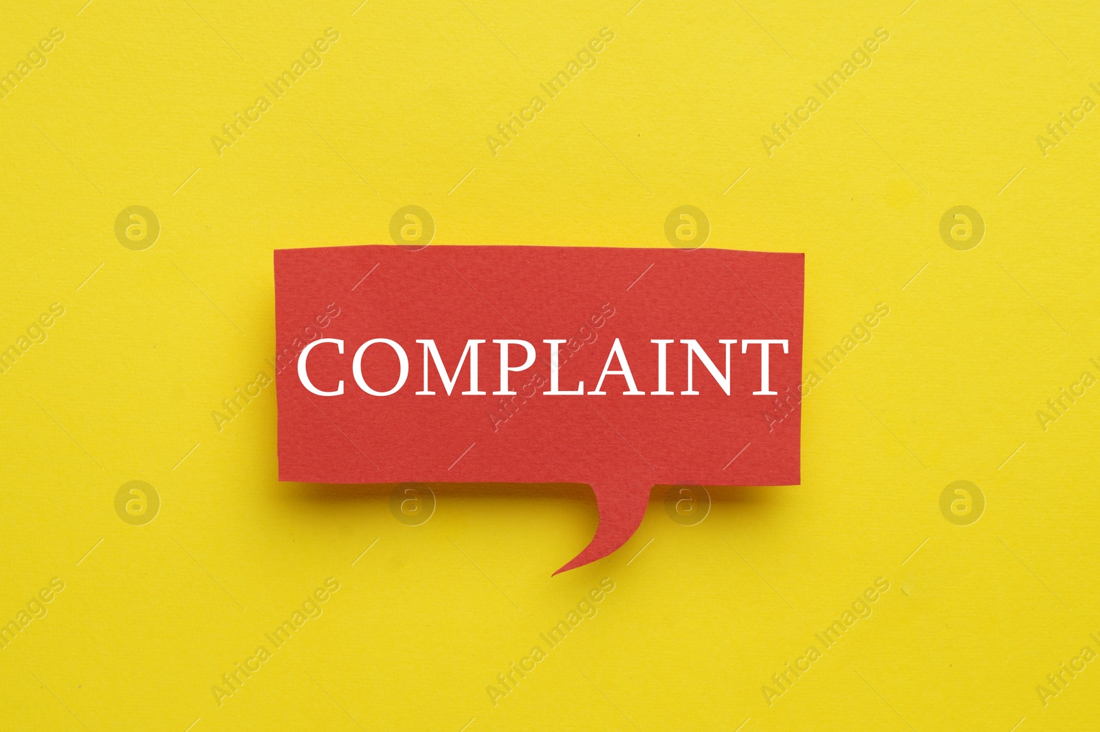 Image of Paper speech bubble with word Complaint on yellow background, top view