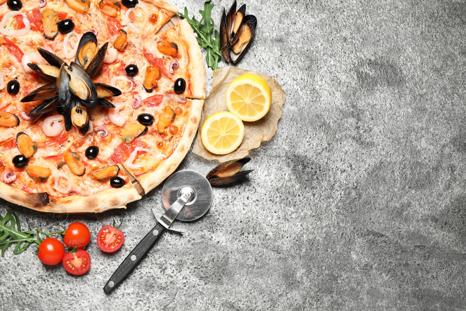 Photo of Tasty pizza with seafood and ingredients on grey table, flat lay. Space for text