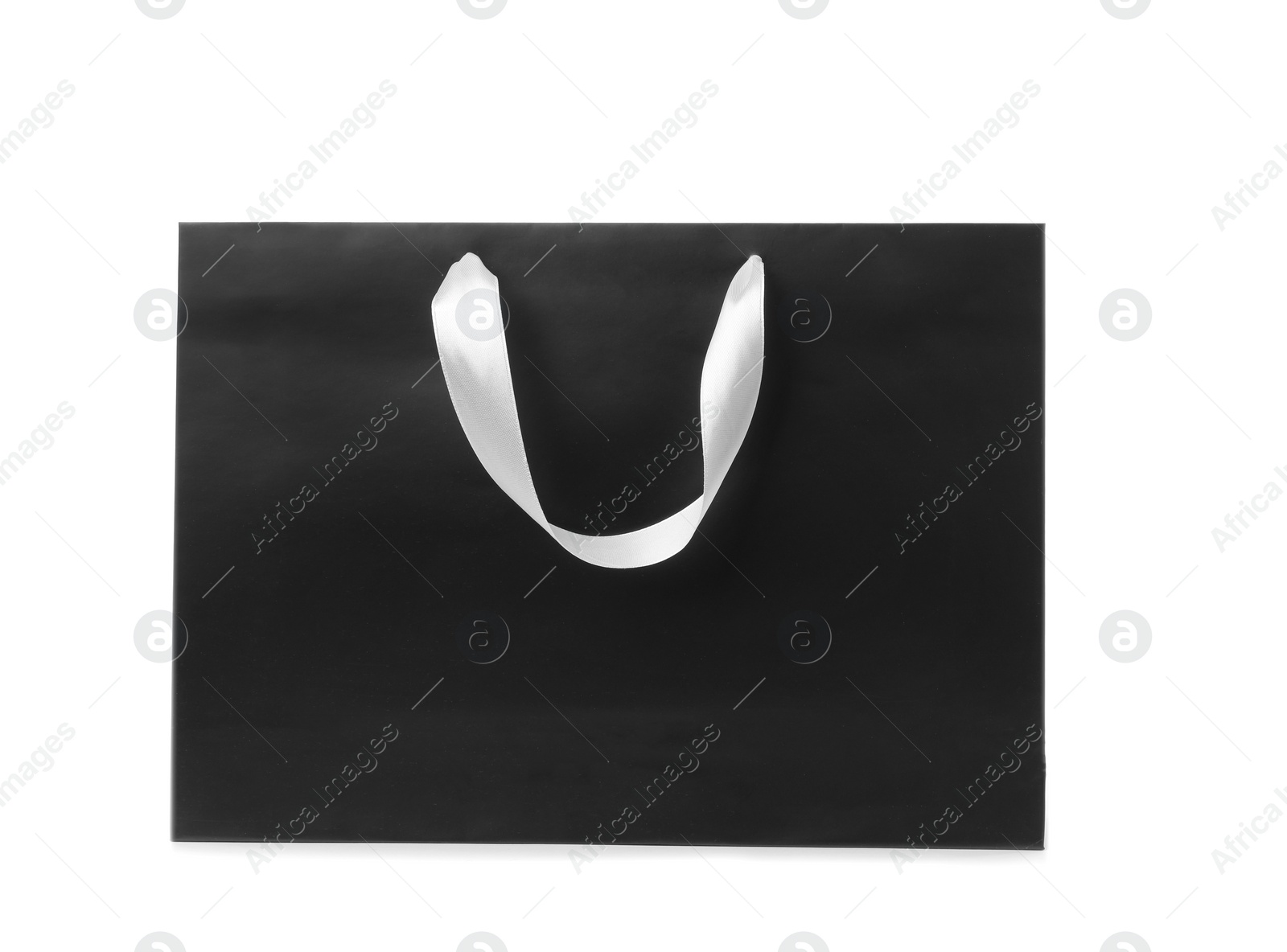 Photo of Paper shopping bag with ribbon handles on white background. Mockup for design