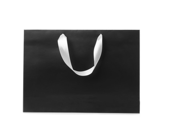 Photo of Paper shopping bag with ribbon handles on white background. Mockup for design