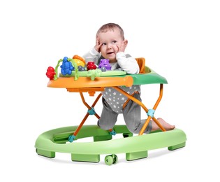 Portrait of cute little boy in baby walker on white background