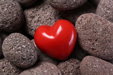 Photo of One red decorative heart on stones, above view
