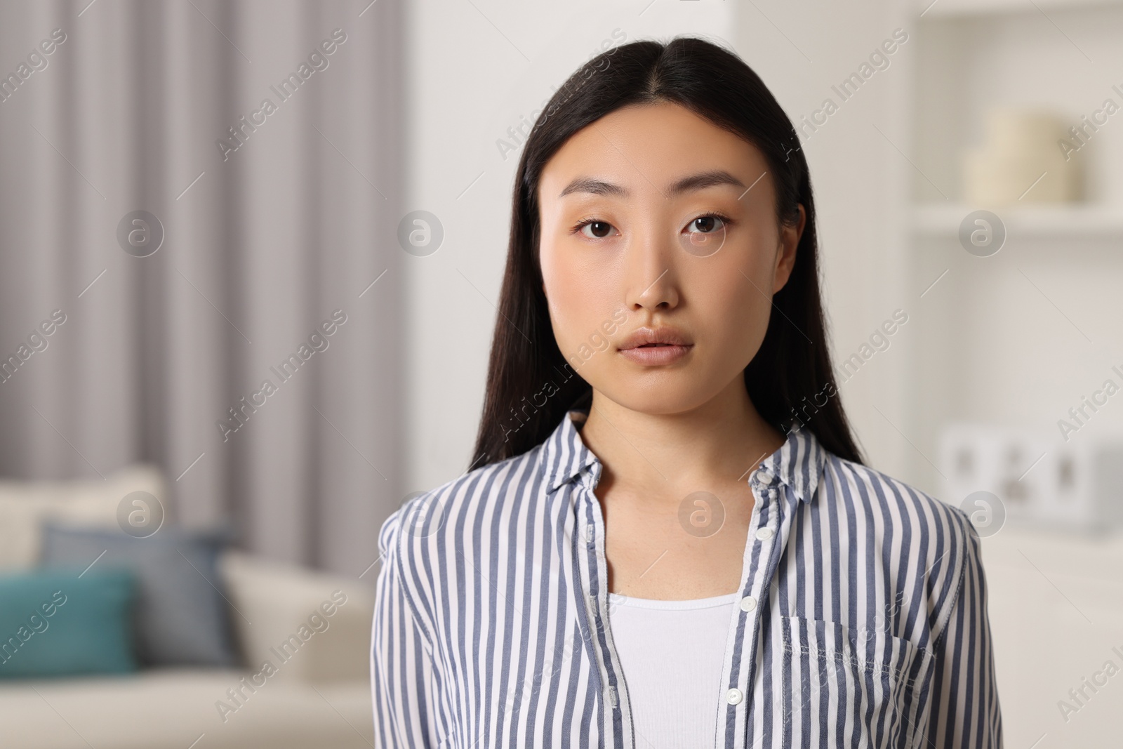 Photo of Portrait of beautiful young woman on blurred background, space for text