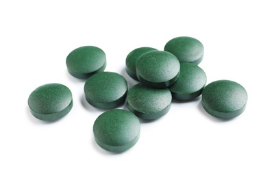 Photo of Spirulina tablets on white background. Healthy lifestyle