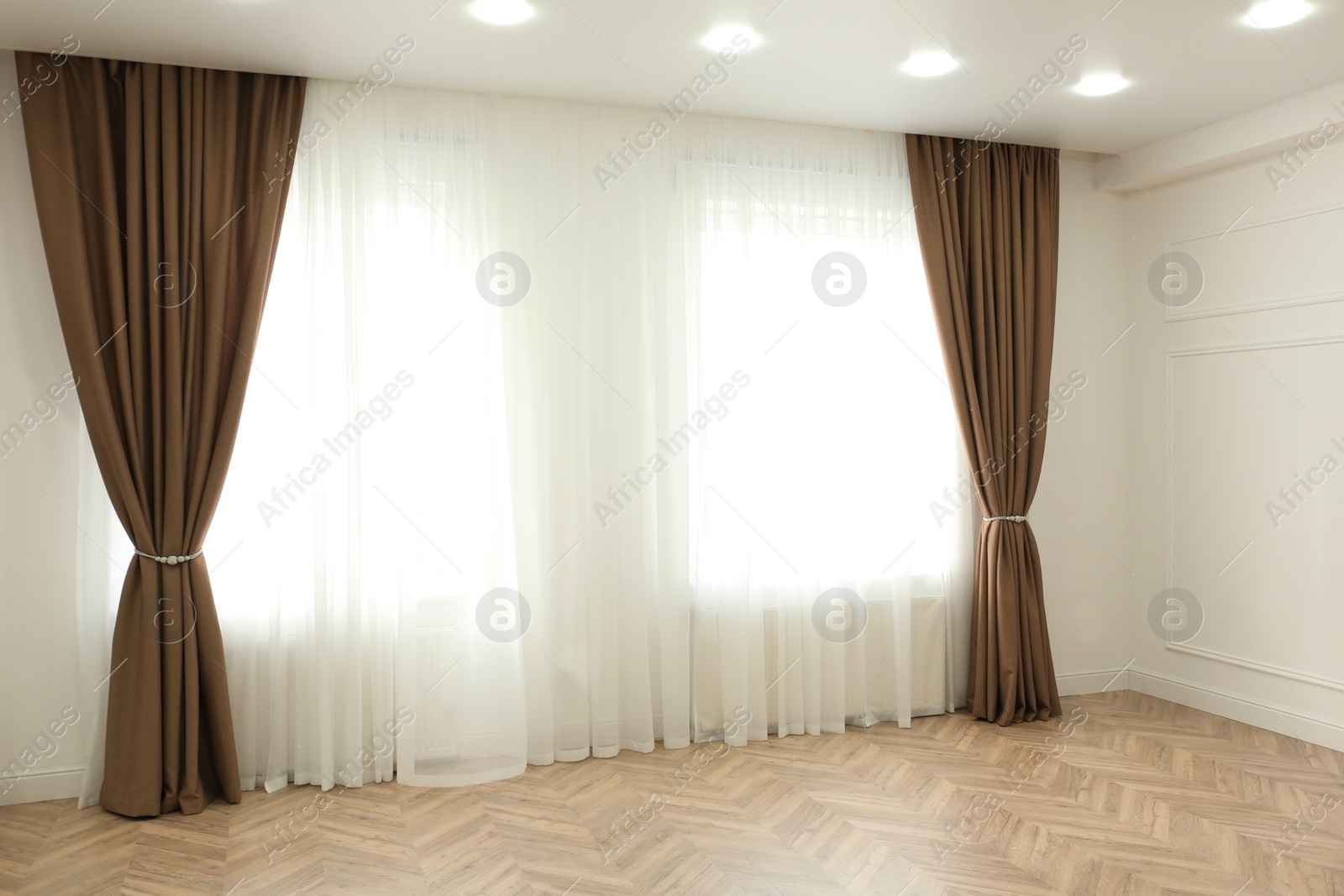 Photo of Windows with elegant curtains in modern room