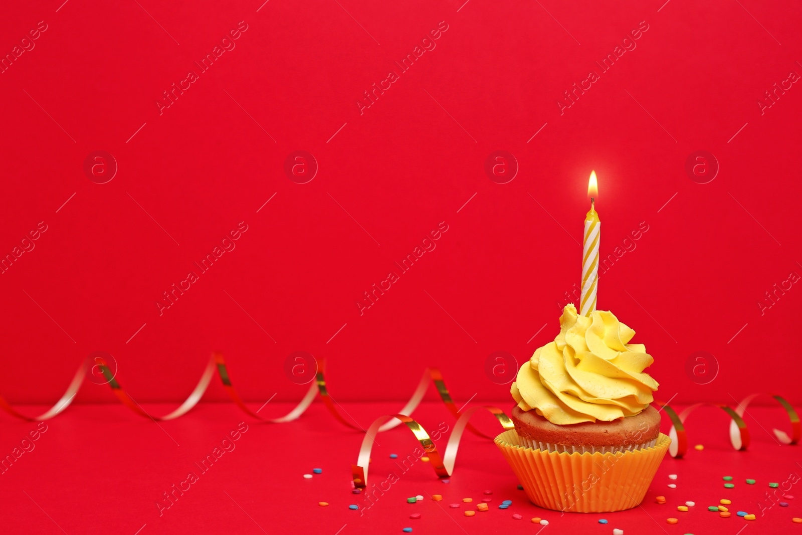 Photo of Birthday cupcake with candle on color background