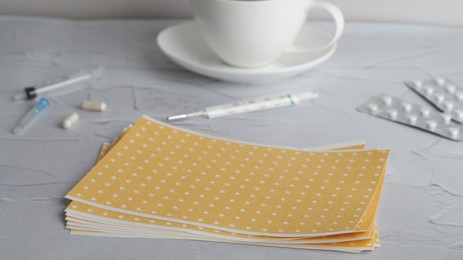 Photo of Pepper plasters on white textured background, closeup