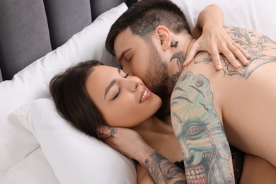 Passionate young couple having sex on bed