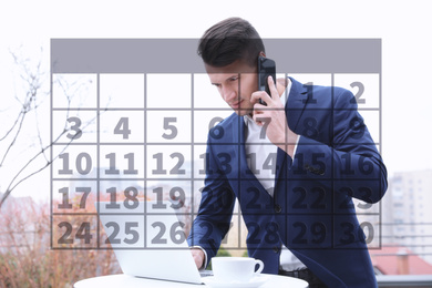 Calendar and man working with laptop in outdoor cafe