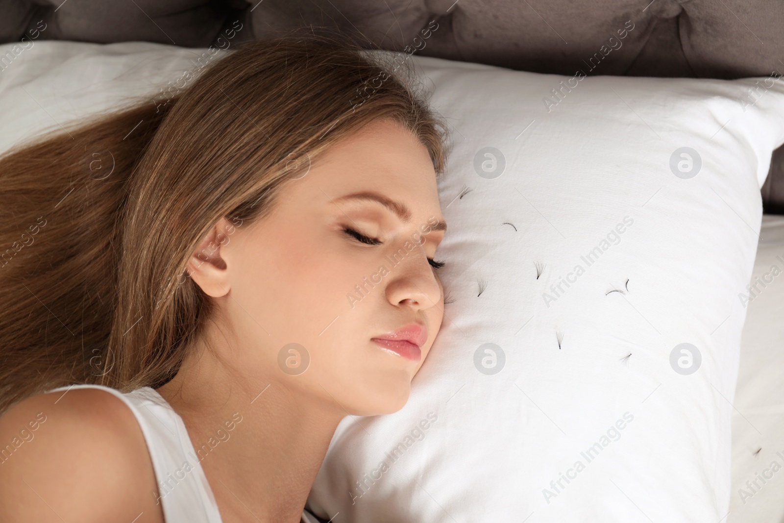 Photo of Young woman with eyelash loss problem sleeping in bed. Space for text