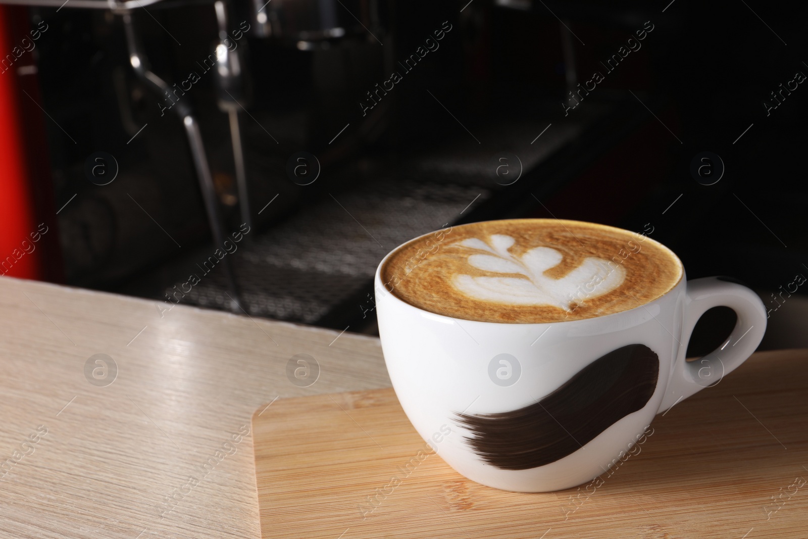 Photo of Cup of fresh aromatic coffee on wooden counter in cafe, space for text