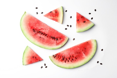 Flat lay composition with slices and seeds of watermelon on white background