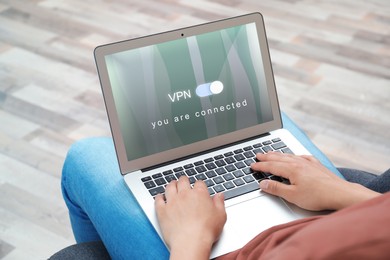 Image of Man using laptop with switched on VPN indoors, closeup