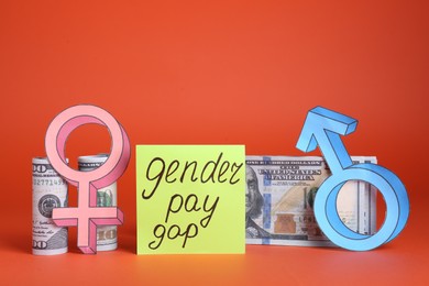 Gender pay gap. Male and female symbols near paper note, dollar banknotes on red background