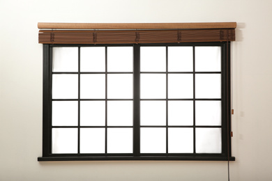 Photo of Window with open brown blinds in room