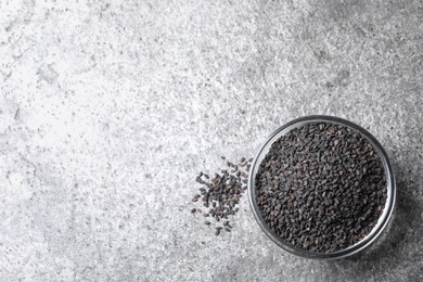 Photo of Black sesame seeds on grey table, flat lay. Space for text
