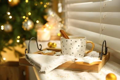 Composition with cup of hot drink on windowsill