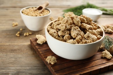 Photo of Dried soy meat on wooden table. Space for text