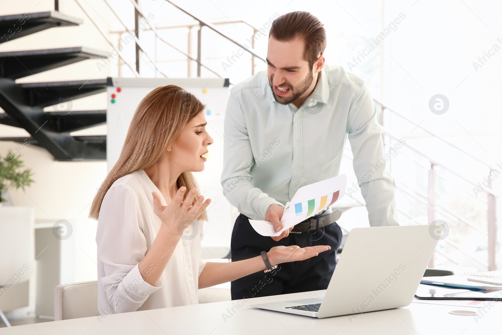 Photo of Office employees having argument at workplace