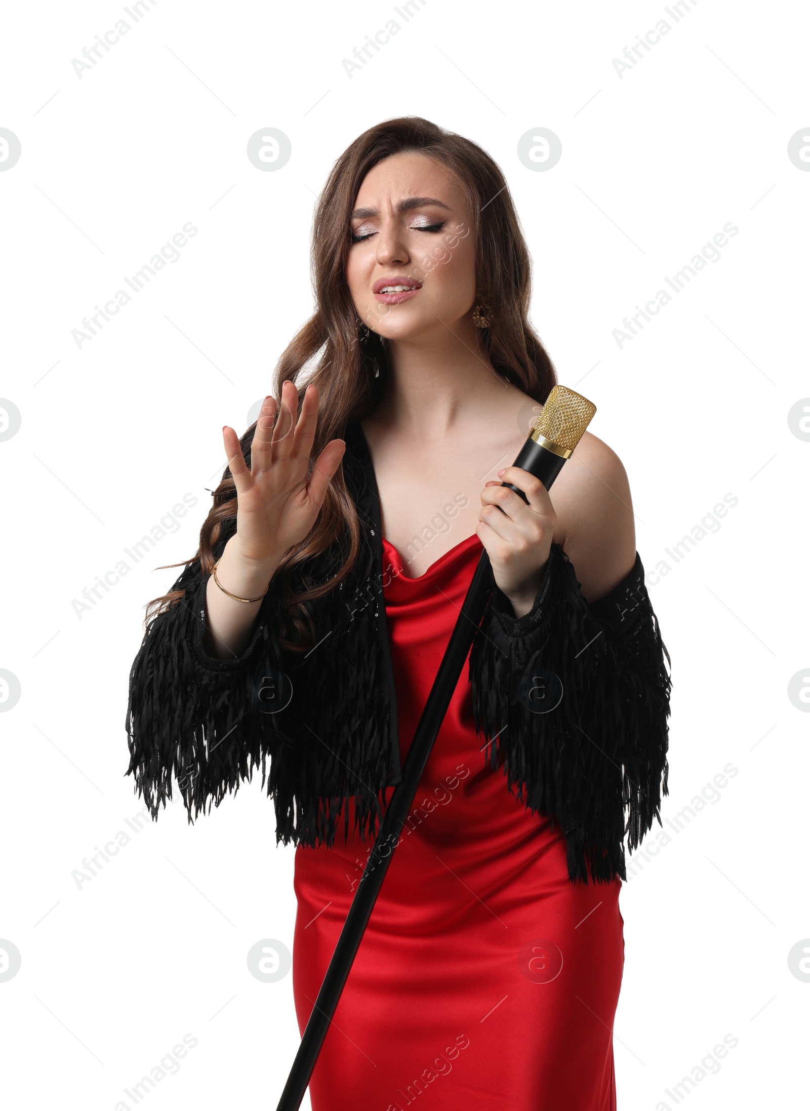 Photo of Beautiful young woman in stylish red dress with microphone singing on white background