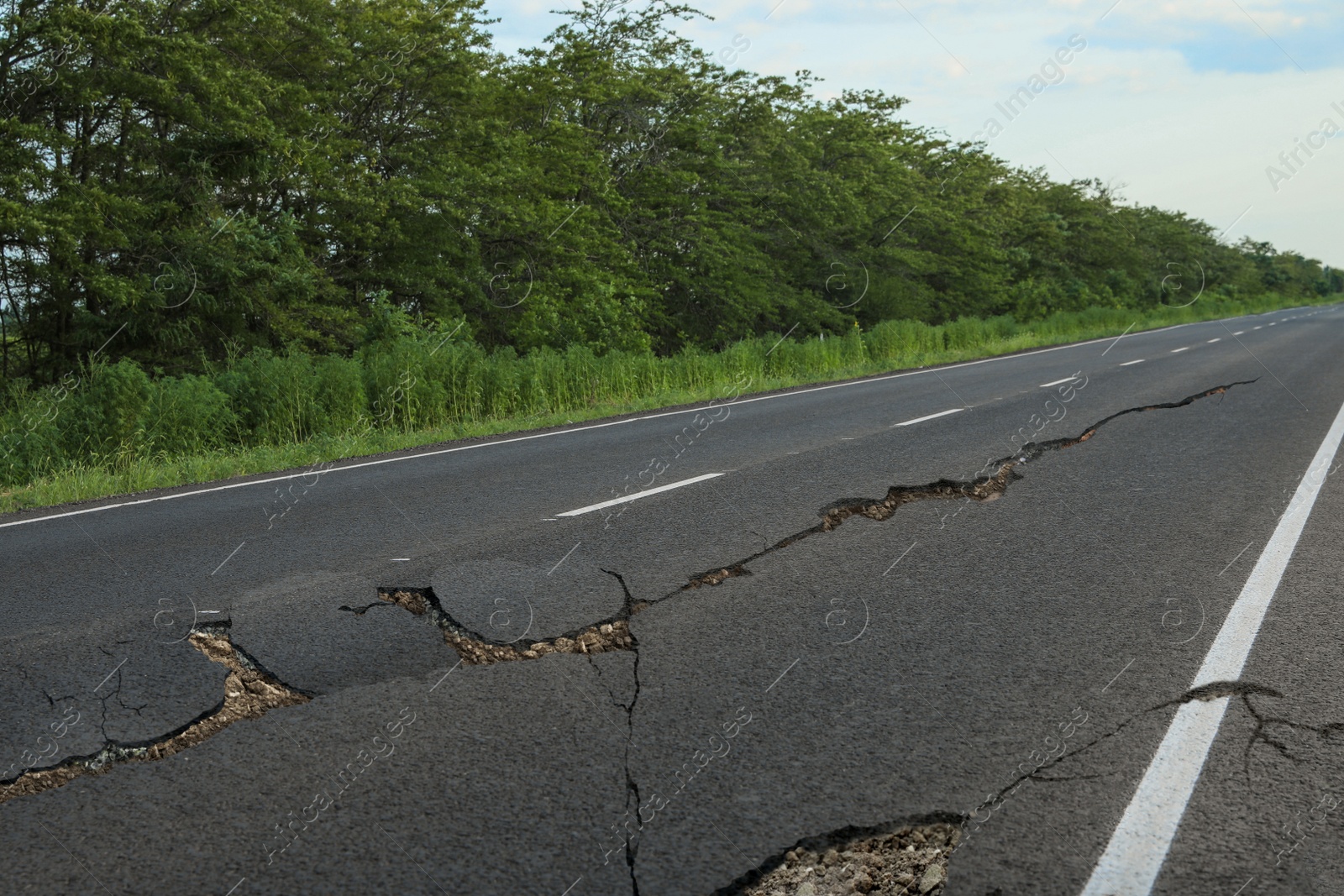 Image of Large cracks on asphalt road after earthquake