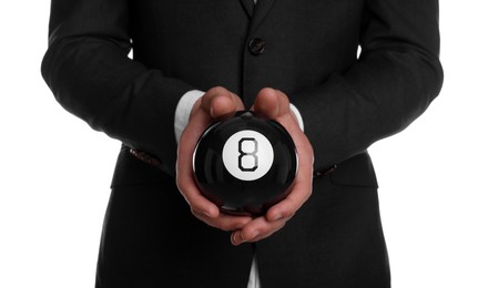 Man holding magic eight ball on white background, closeup