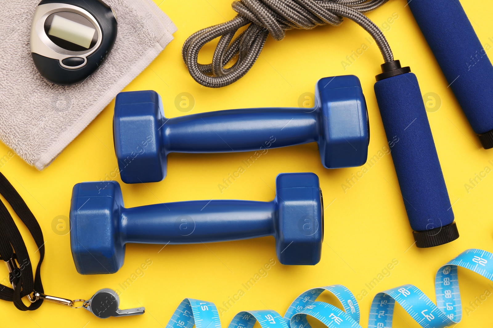 Photo of Flat lay composition with dumbbells on yellow background