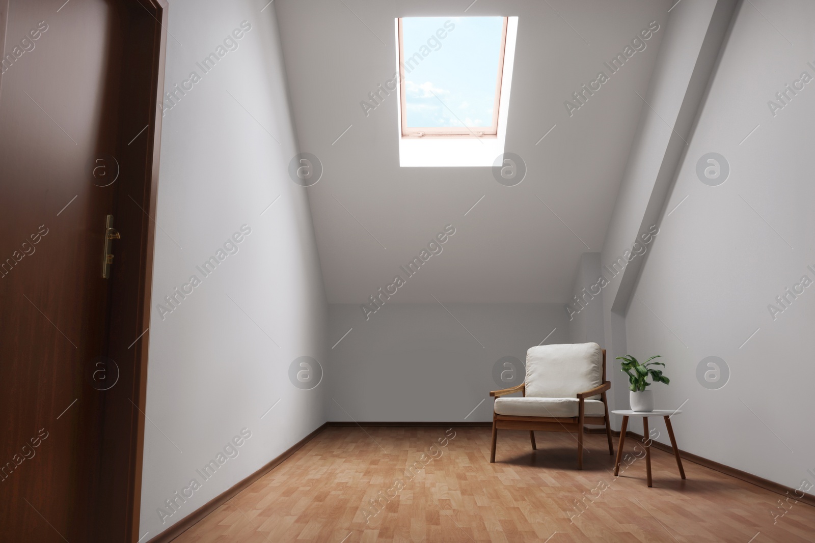 Photo of Attic spacious room interior with slanted ceiling and furniture