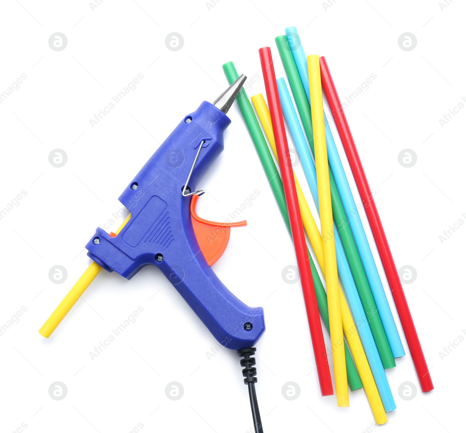 Photo of Blue glue gun and colorful sticks on white background, top view