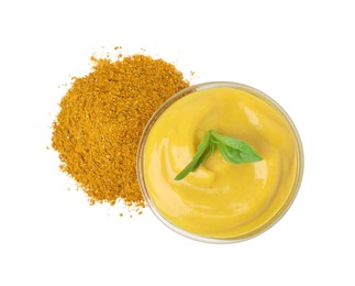 Bowl with tasty curry sauce, powder and basil isolated on white, top view