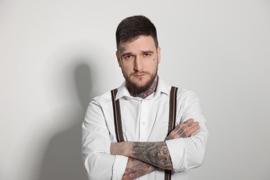 Portrait of handsome hipster man on light grey background