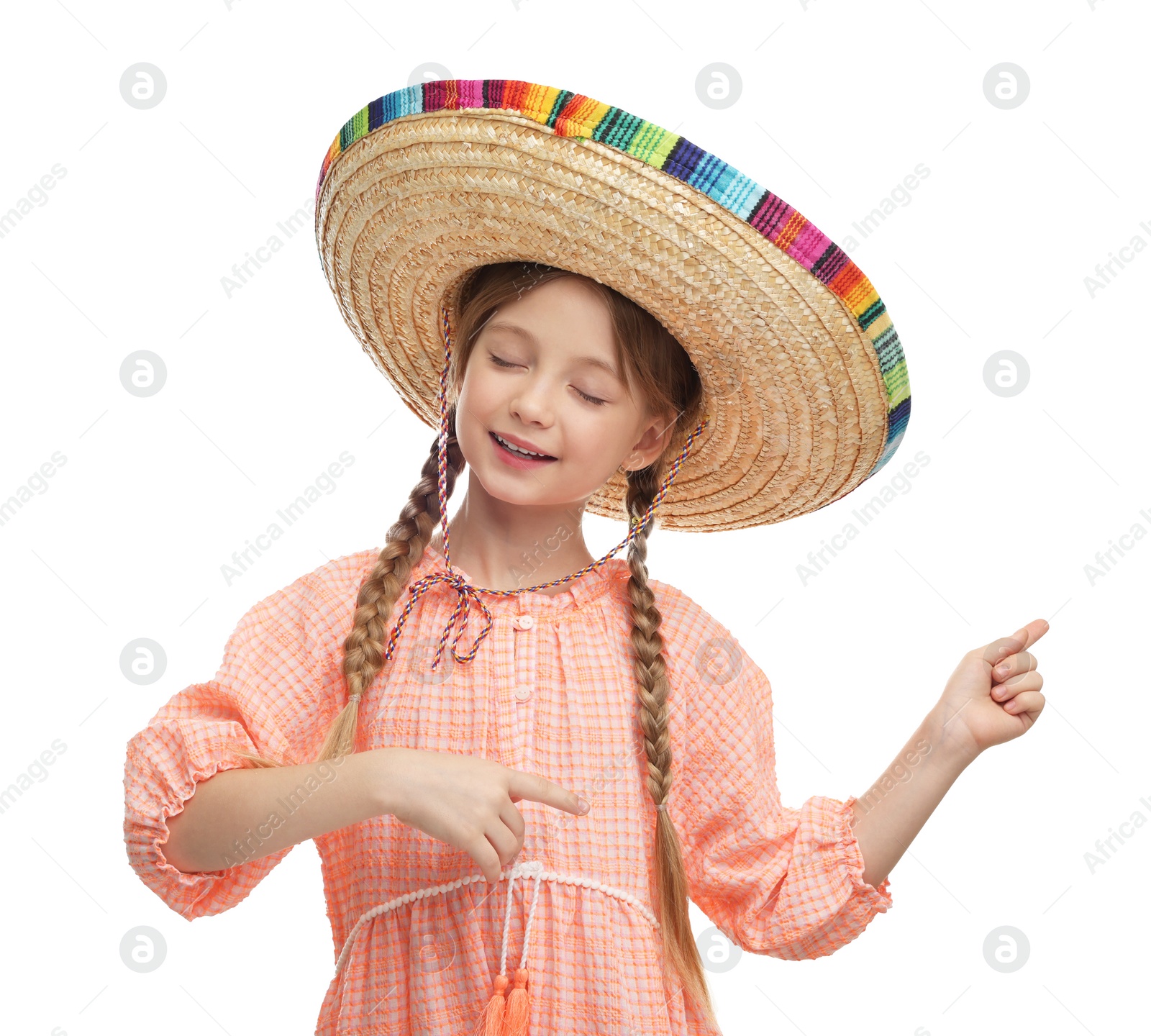 Photo of Cute girl in Mexican sombrero hat dancing on white background