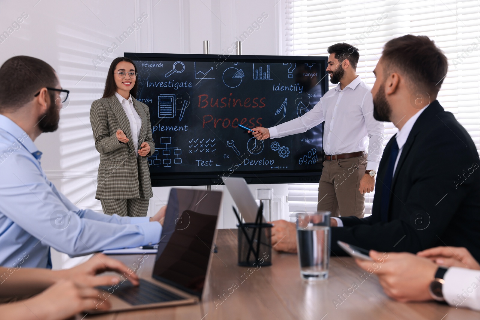 Photo of Business training. People in meeting room with interactive board