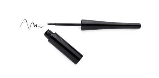 Photo of Black eyeliner and stroke on white background, top view. Makeup product