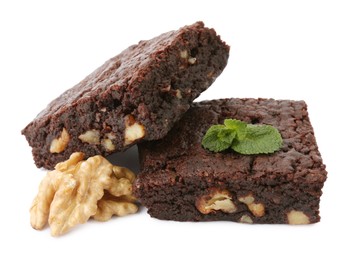 Delicious brownies with walnuts and mint on white background