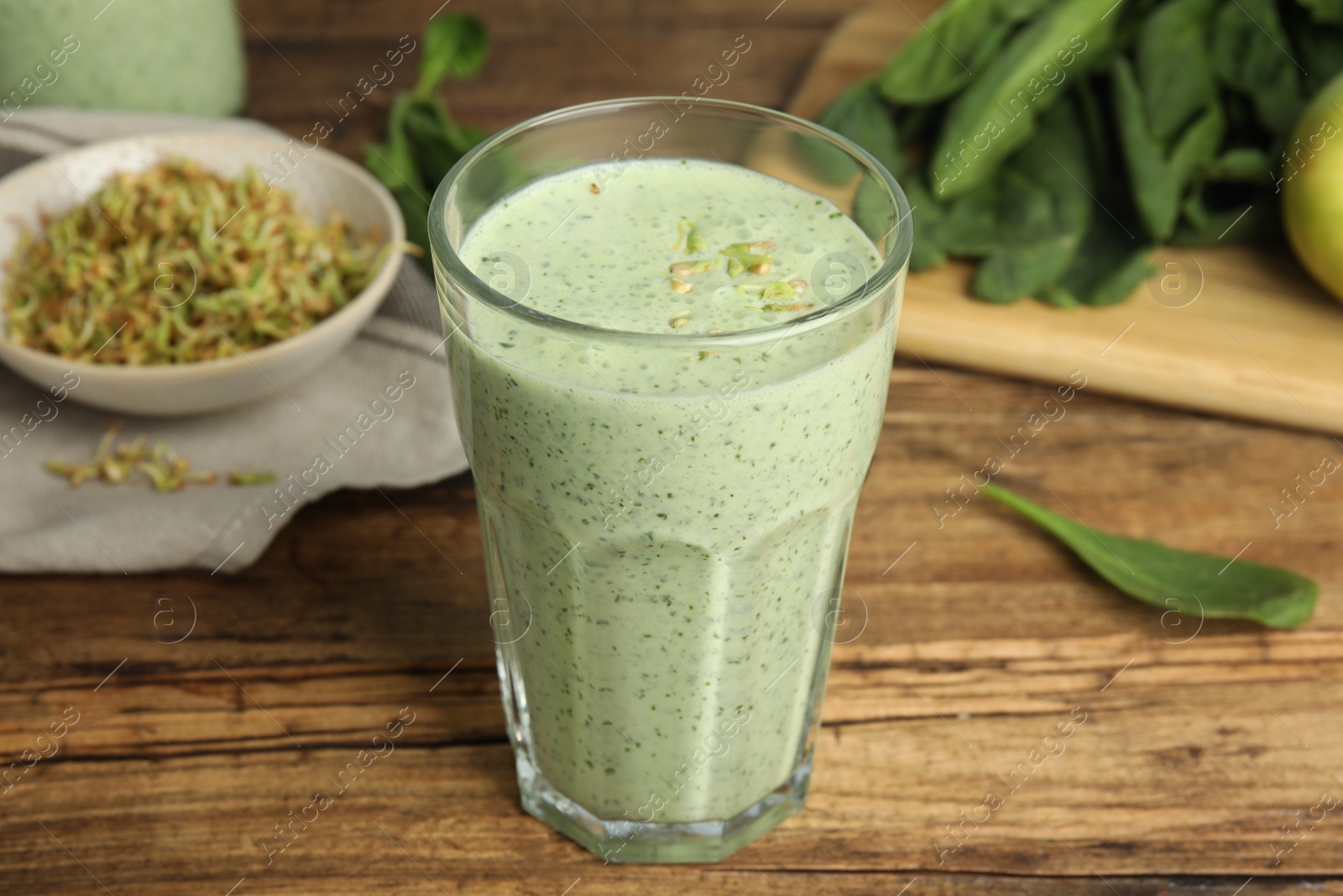 Photo of Tasty green buckwheat smoothie on wooden table