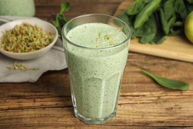 Tasty green buckwheat smoothie on wooden table