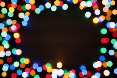 Photo of Blurred view of frame made with colorful Christmas lights on light background. Bokeh effect