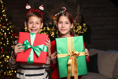 Photo of Portrait of happy children with Christmas gifts at home