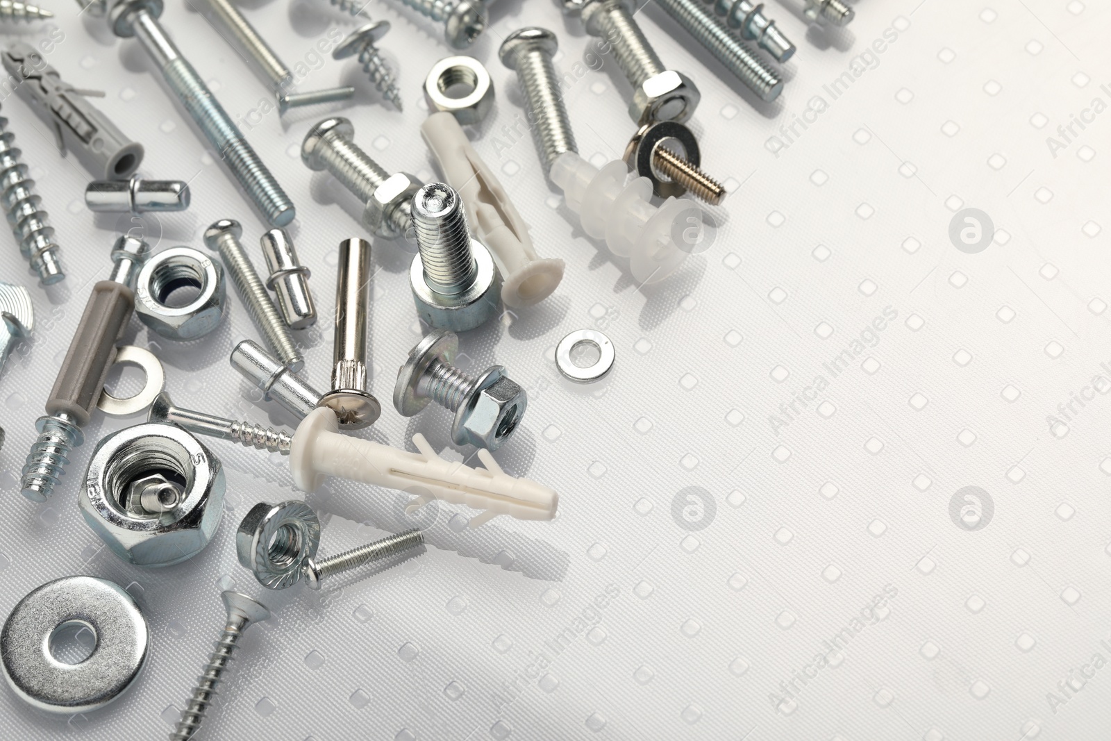 Photo of Many different fasteners on plastic surface, closeup. Space for text