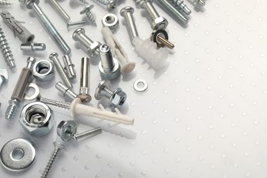 Many different fasteners on plastic surface, closeup. Space for text