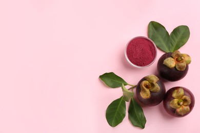 Purple mangosteen powder and fruits on pink background, flat lay. Space for text