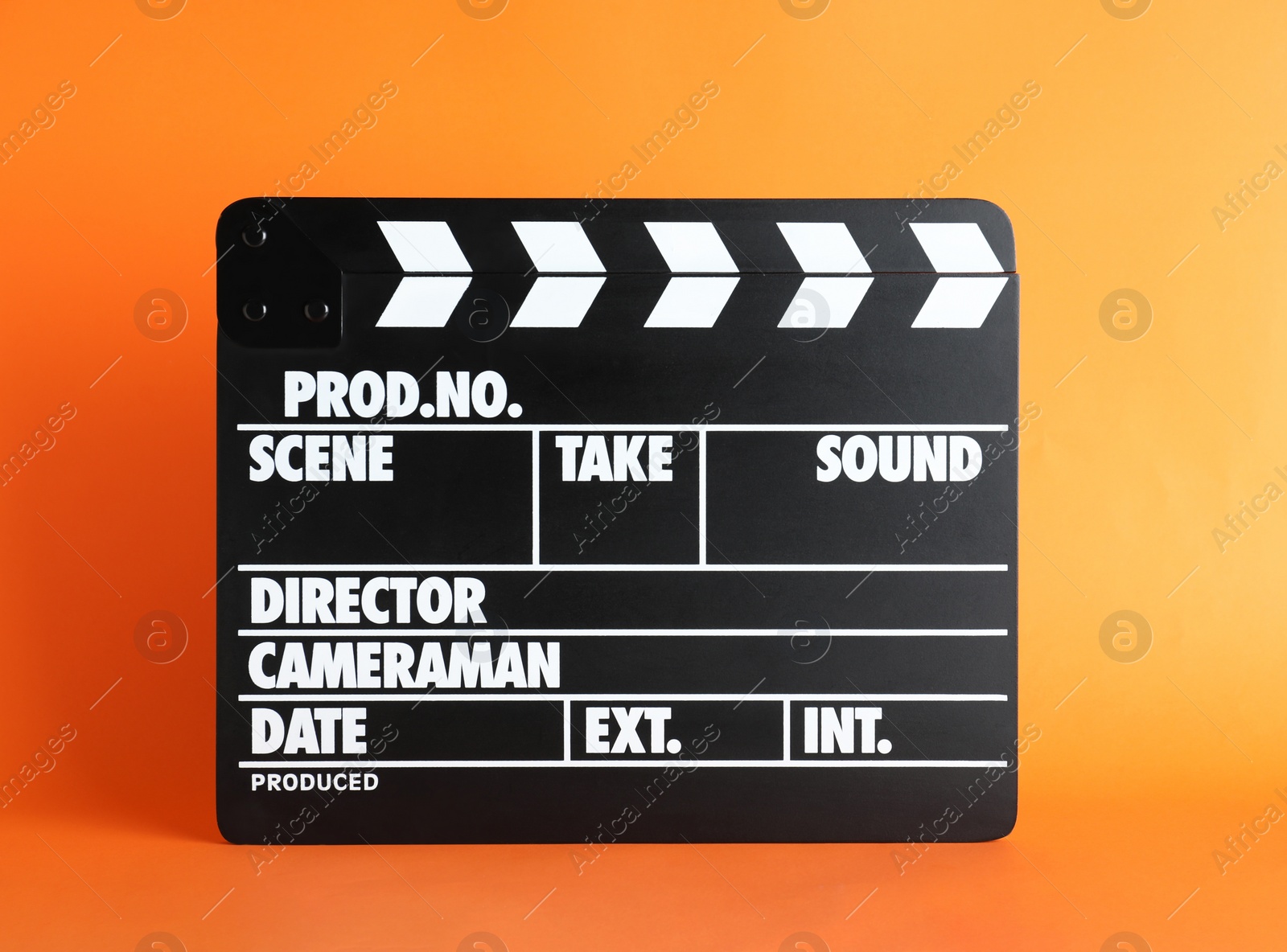 Photo of Clapper board on orange background. Cinema production