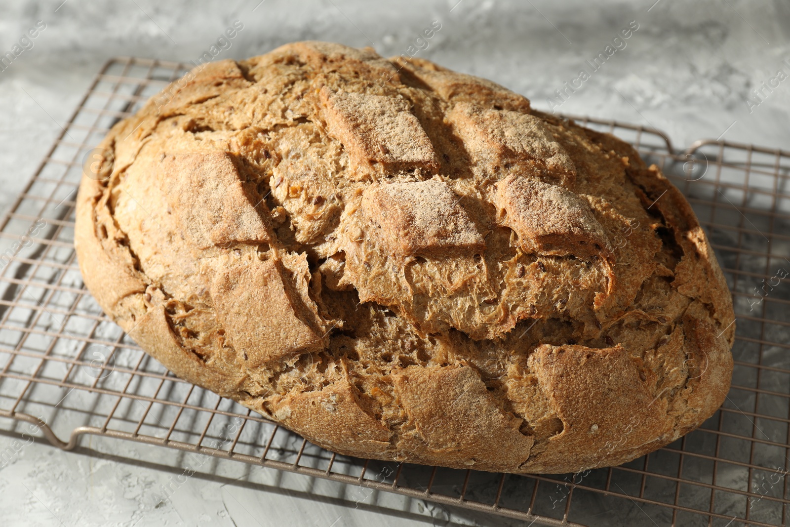 Photo of Freshly baked sourdough bread on grey table, closeup