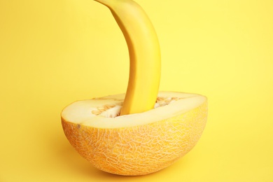 Fresh banana and melon on yellow background. Sex concept