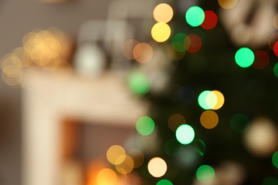 Photo of Blurred view of room interior with decorated Christmas tree