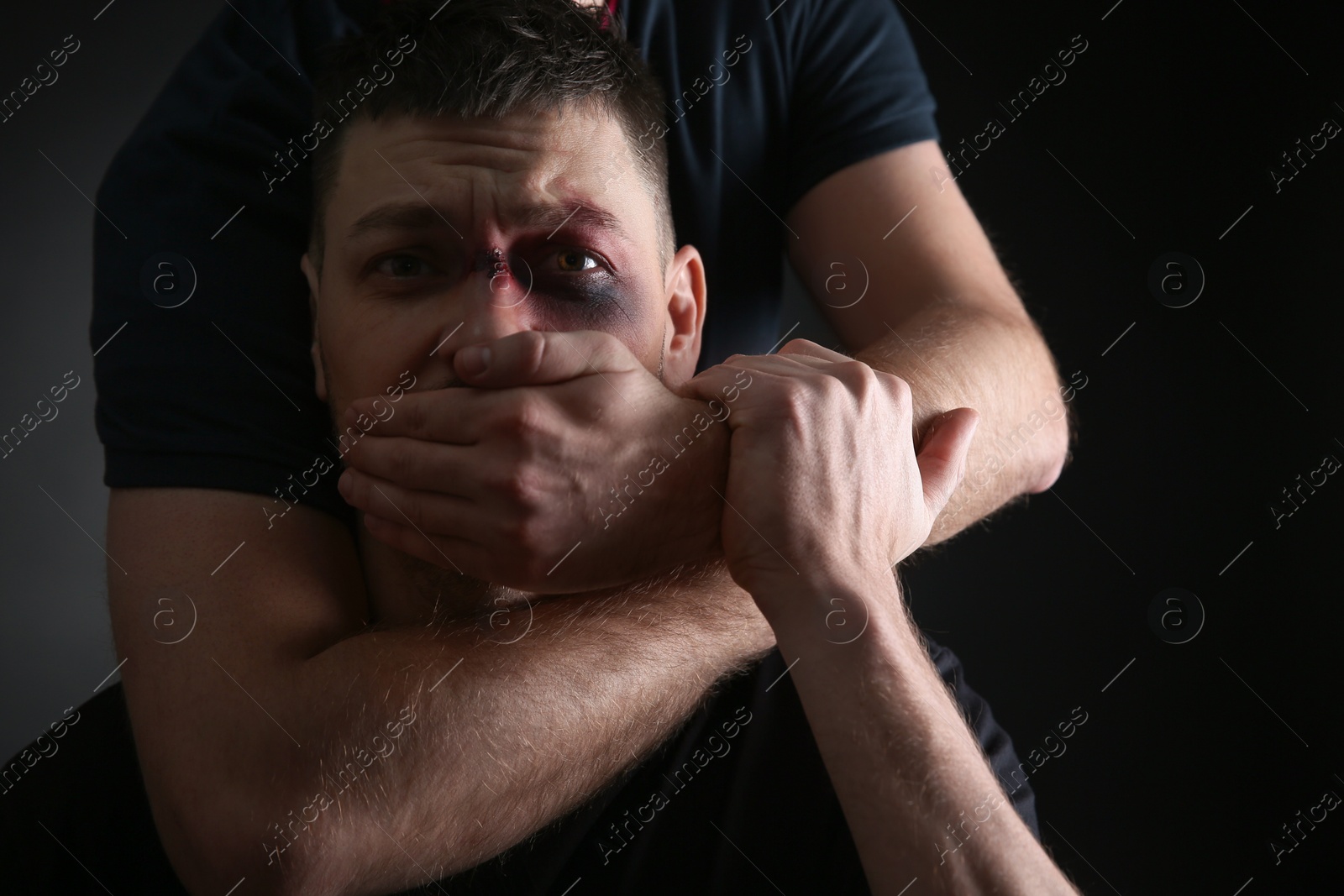 Photo of Person abusing adult man on black background. Domestic violence