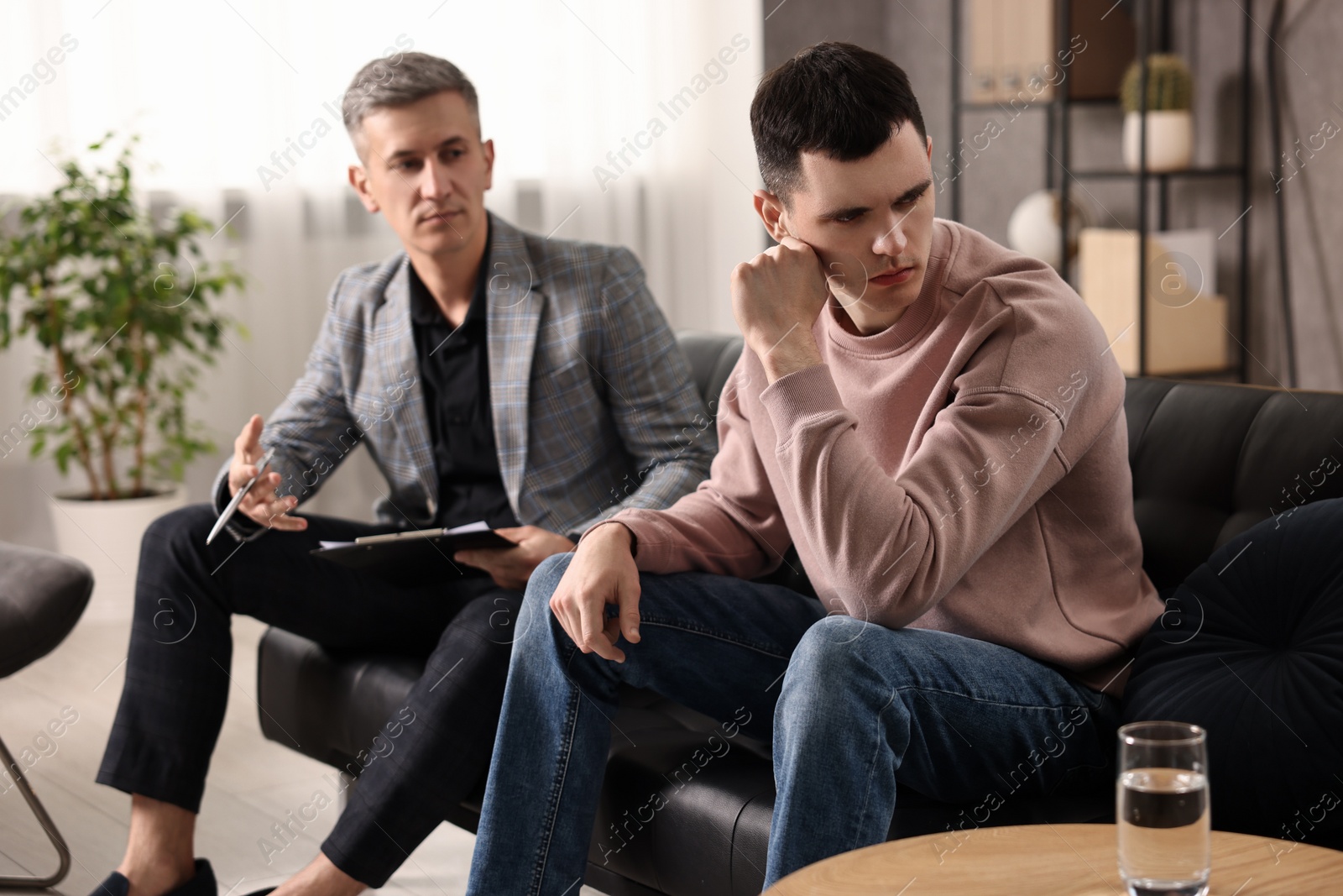 Photo of Professional psychotherapist working with patient in office