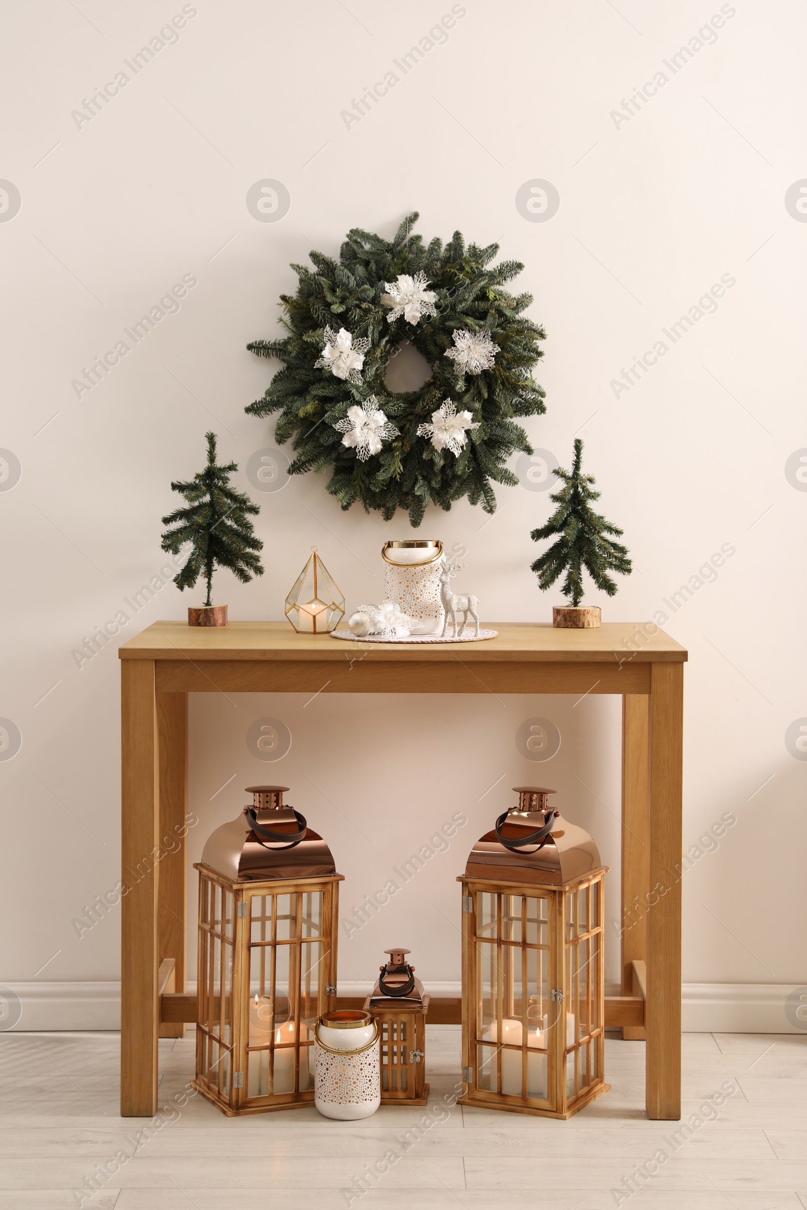 Photo of Table with Christmas decor in room. Interior design