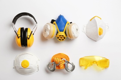 Photo of Flat lay composition with safety equipment on white background